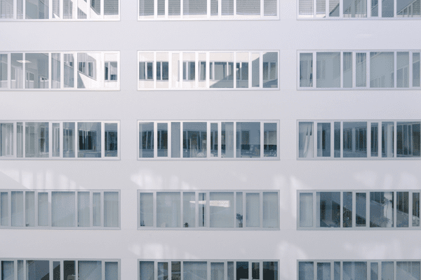 A straight across view of an office building with 3M film installed by NGS.