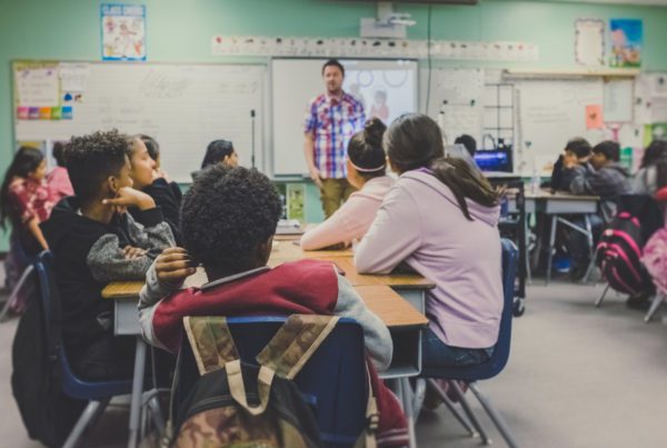 students in classroom with teacher in school