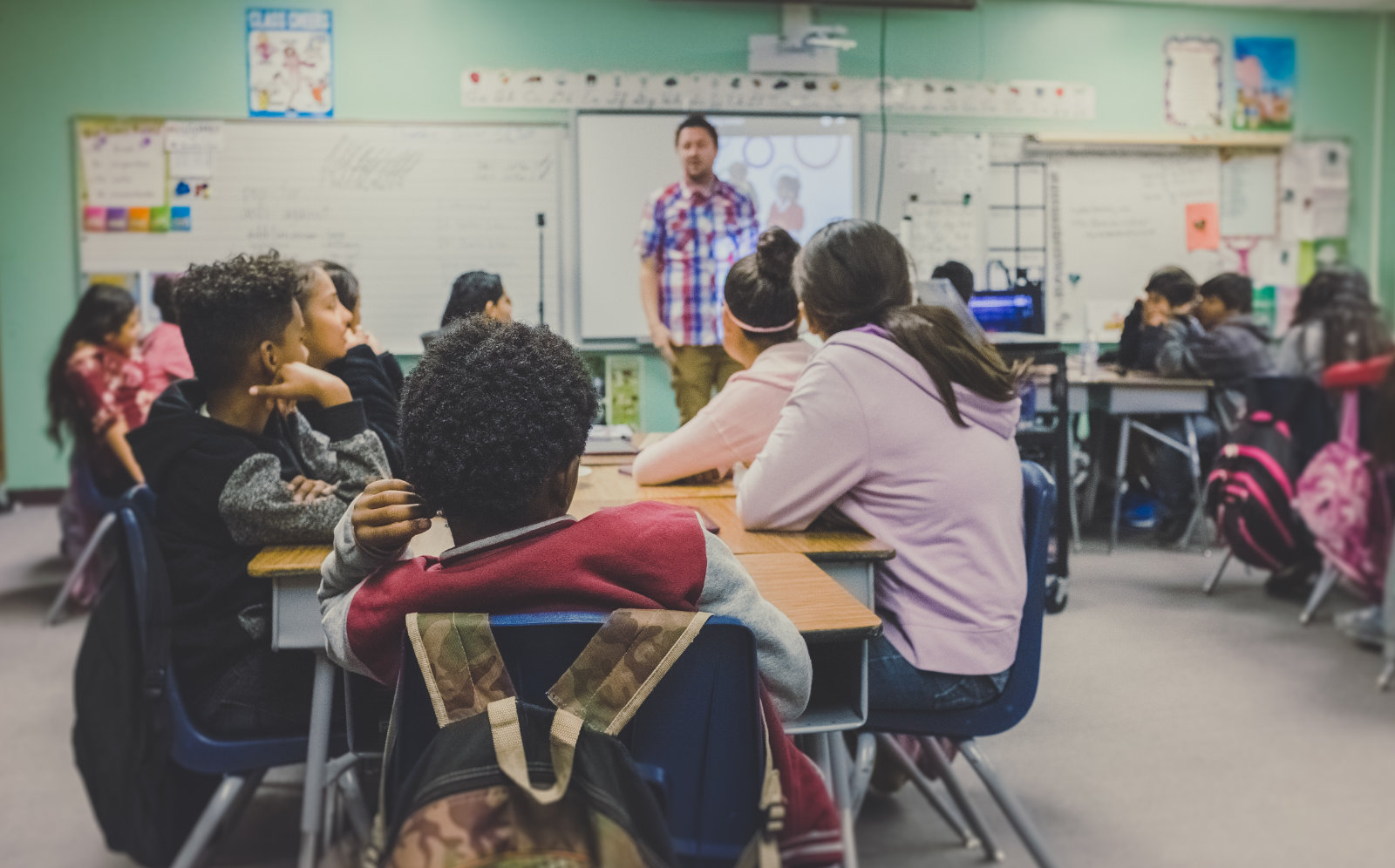 students in classroom with teacher in school