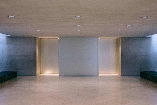 White elevators in a lobby with belbien film
