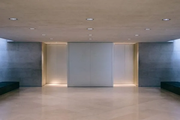 White elevators in a lobby with belbien film