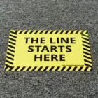 A sign stating where the line starts. This is a add on to a floor package you can purchase from NGS.