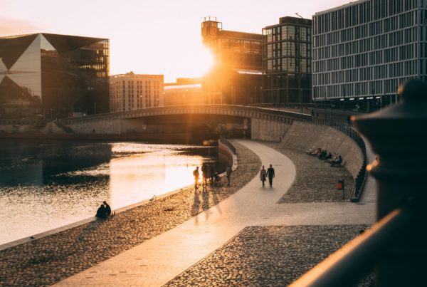 Image of people enjoying a walk alongside a riverway