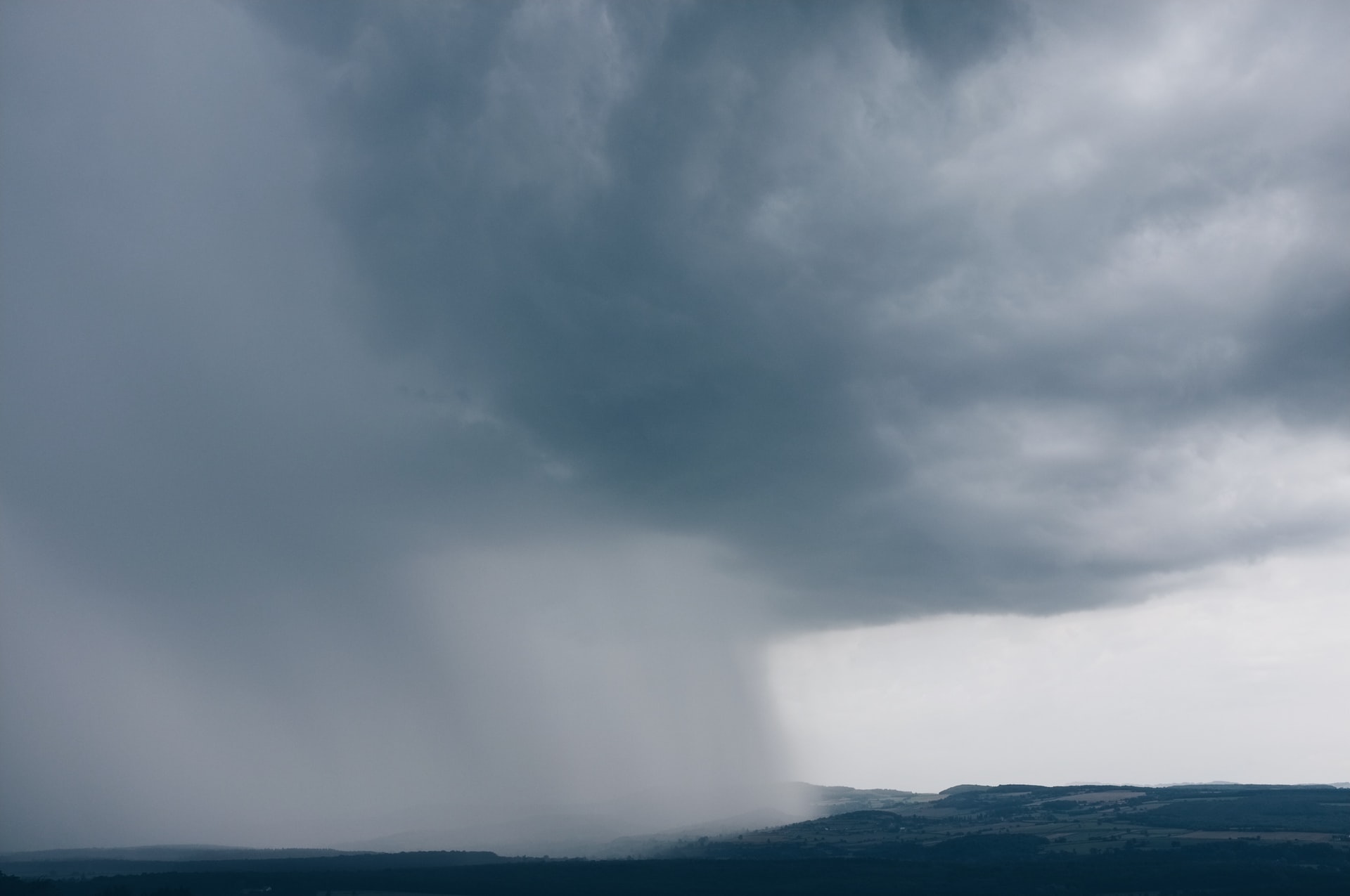 Rain cloud dropping rain over land