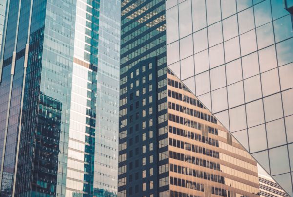 Buildings with dual-reflective window film