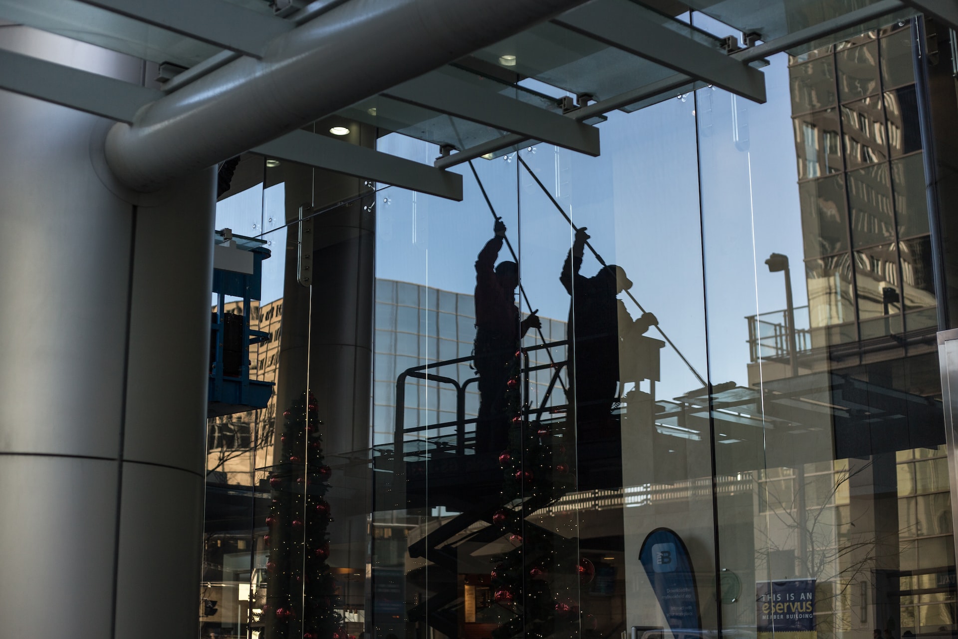 3M Window Film Installers Working on a Window