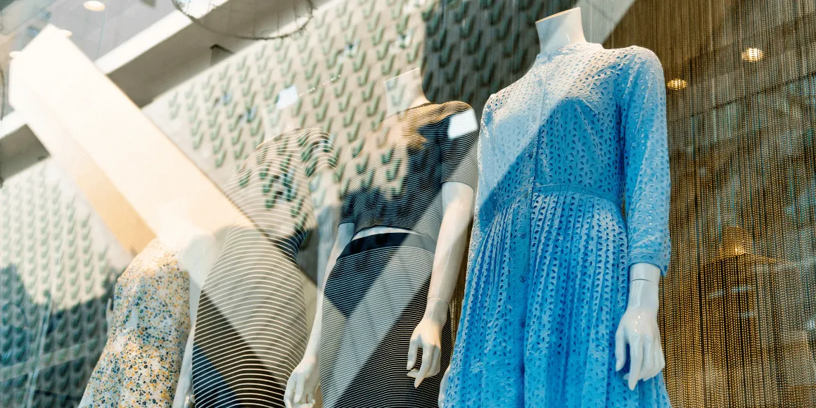 Retail display with four mannequins in a storefront window