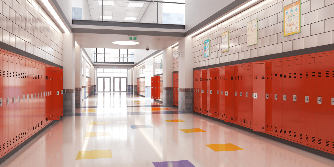 empty school halfway lined with red lockers and colored floors